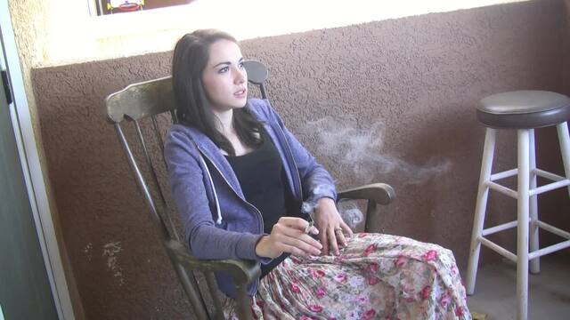 Emily Grey takes a smoking break